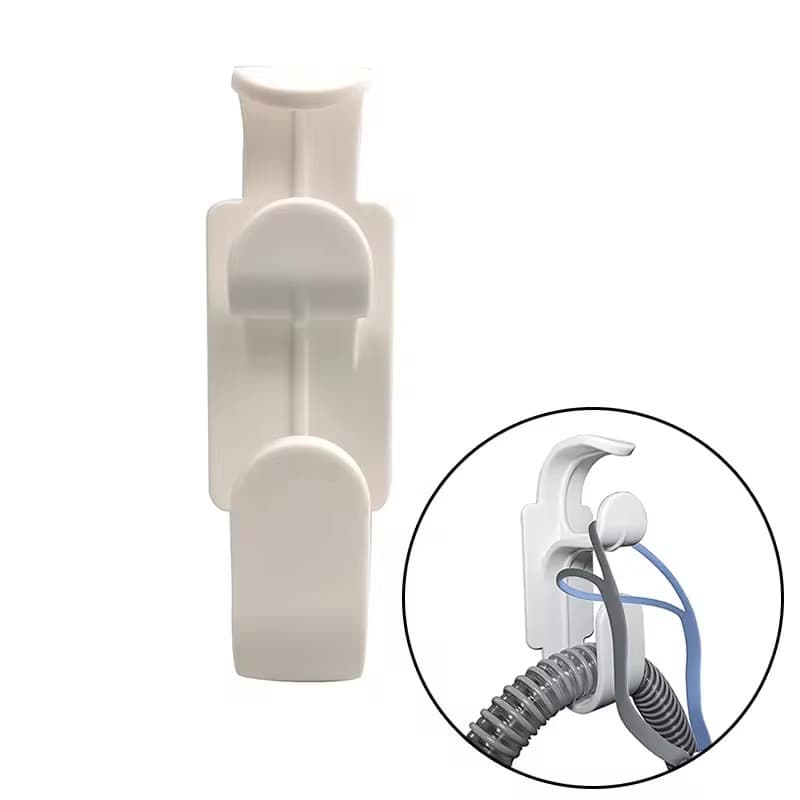 TangleRest wall-mounted CPAP hose and mask holder installed beside a bed